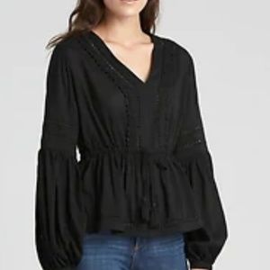 Really cute black top with pom pom detail